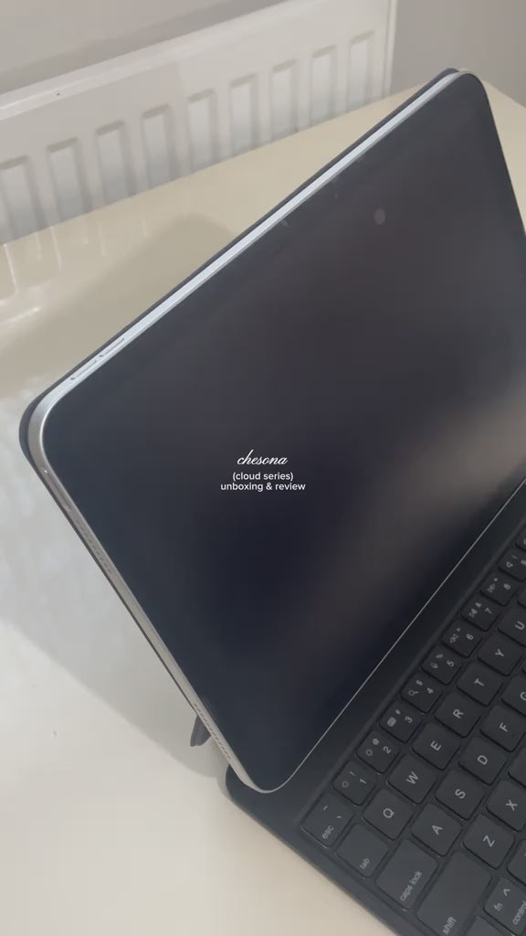 Creator unboxes a black CHESONA Cloud 1 iPad keyboard case and demonstrates the backlit keyboard and browsing videos on the iPad.